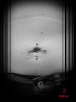 close up of double navel piercing